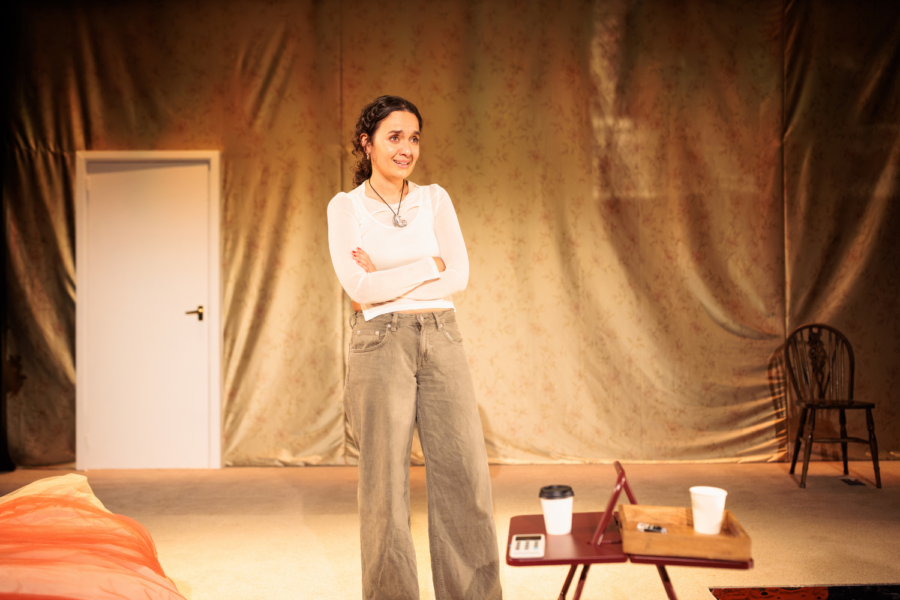 Production photo: Nadi Kemp-Sayfi stands with her arms crossed.